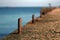 Marina bollard bitt at jetty for boats, ships and yachts mooring. Old broken rusty metal sticks on a pier