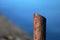 Marina bollard bitt at jetty for boats, ships and yachts mooring. Old broken rusty metal sticks on a pier