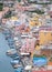 Marina Corricella, Italy, fishing village on the island of Procida with pastel coloured houses tumbling down the cliff to the se