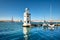 Marina and lighthouse tower on San Giorgio di Maggiore with city of Venice behind. Venezia, Italy, Europe. Sailing boats