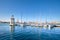 Marina and lighthouse tower on San Giorgio di Maggiore with city of Venice behind. Venezia, Italy, Europe. Sailing boats