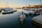 Marina with moored boats in the Croatian town of Malinska on the island of Krk during sunset