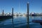 Marina pilings reflected in blue water