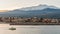 The marina of Riposto during the sunset; volcano Etna in the background