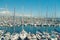 Marina with white sailboats and yachts on sunny day