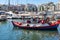 Marina Zeas in Piraeus, Greece. Many fishing-boats ready to sail in calm sea. City and sky background