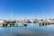 Marina Zeas in Piraeus, Greece. Many moored yachts. Reflection of boats, blue calm sea, city and sky background
