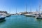 Marina Zeas in Piraeus, Greece. Many moored yachts. Reflection of boats, blue calm sea, city and sky background, space