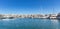 Marina Zeas in Piraeus, Greece. Many moored yachts. Reflection of boats, blue calm sea and sky background, banner, panoramic