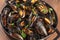 Marinara mussels, mules mariniere, in a braizer, close-up view