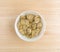 Marinated artichoke hearts in a bowl atop a table