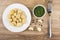 Marinated champignons in plate, dill in bowl, slices of garlic