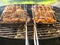 Marinated chicken portions in metal grilling basket, Cooking food on fire. Summer barbeque time theme. Picnic in a park or back