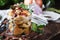 Marinated forest white mushrooms boletus in glass jar with spices and herbs, ready to eat, cooking food or canning concept, wooden