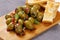 Marinated green olives with toasts