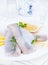 Marinated herring fillet on a white plate with lemon and onion. Traditional spring delicacy of the Netherlands. Typical cooking