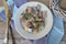 Marinated herring on plate with fresh dill on shabby table, russian food