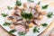 Marinated herring with sliced onion and dill