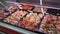 marinated meat of chicken, pork and beef in display case of meat shop, panoramic shot