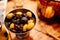 Marinated olives and prunes in a metal plate. snacks for dinner. Italian food