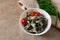 Marinated oyster mushrooms, garnished with cherry tomatoes and green dill. A dish with onions and butter in a white plate with