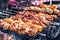 Marinated shashlik preparing on a barbecue grill over charcoal. Shashlik or Shish kebab popular in Eastern Europe.