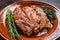 Marinated skirt bavette steaks in bbq sauce on a plata. Dark background. Top view