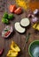 Marinating meat and fresh vegetables on wooden table