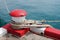 Marine bollard and old rope on pier used and footpath color red and white no parking in the area in this area