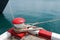 Marine bollard and old rope on pier used and footpath color red and white no parking in the area in this area