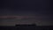 Marine cargo ship or tanker at night in the ocean. A large cargo ship is in the roadstead near the shore. Sea transport