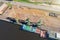 Marine cranes at the pier ready for loading bulk cargo onto a barge, aerial view