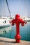 Marine fire hydrant on the quay in front of the yachts