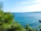 Marine landscape, Adriatic Sea , beautiful seaside with branches of pine, boat.