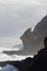 Marine landscape with an inclined rock, waves and cloudy sky on background, West Beach near Auckland, New Zealand