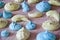 Marine mood with tasty meringues. meringue top view background. sea shell dessert. trendy french cookies flat lay. green and blue