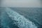 Marine Pathways: Ship\'s Wake Amid Foamy Currents