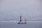 Marine rocky warning light in a foggy day at Istanbul Kartal