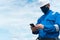 Marine seaman or bosun on deck of vessel or ship. He is speaking on the mobile cell phone