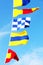 Marine signal flags on a clear blue sky background