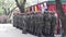 Marine soldiers in camouflage uniform stand alert on guard during military graduation rites.