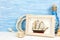 Maritime background with picture frame, ship and bottle on blue