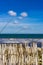 Maritime beach background with dunes sand fence and sea water waves