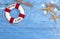 Maritime Decoration with shells, starfish, sailing ship, fishing net on blue drift wood