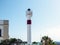 Maritime lighthouse with red stripe and two balconies