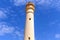 Maritime lighthouse trimmed on blue sky