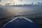 Maritime logistics. The bow of a cruise ship on the open sea with a view of the horizon after sunset