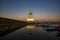 Maritime watchtower of A Coruna reflected in the water at sunset
