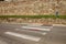 Marked pedestrian crossing that ends at the town wall in Montalcino, Tuscany, Italy.