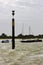 The marker beacon at the entrance to the dredged deep water channel in historic Bosham Harbour in West Sussex in the South of Engl